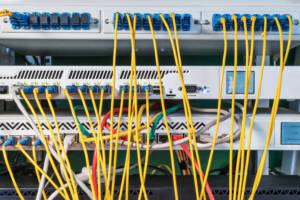 Rack with a lot of routers and wires connected to them